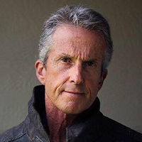 An older man with grey hair and a serious expression, wearing a dark jacket, is featured on the Website Design FAQs section.