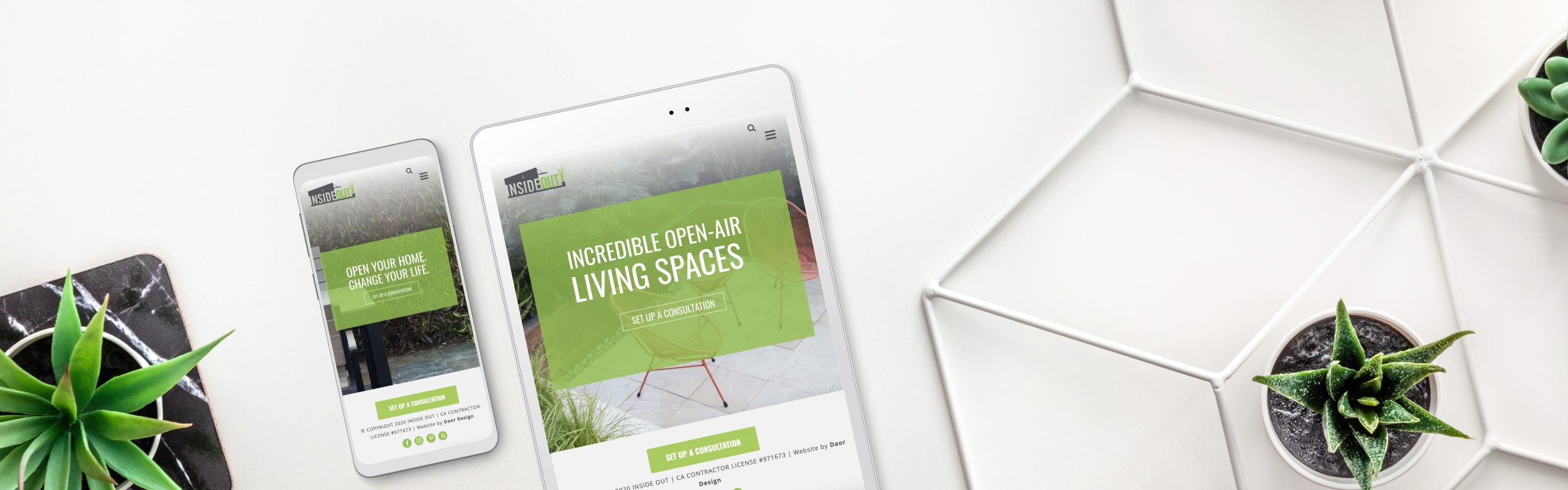Two digital tablets displaying a website with an "Inside Out" green theme about living spaces, positioned on a white surface surrounded by small potted plants.
