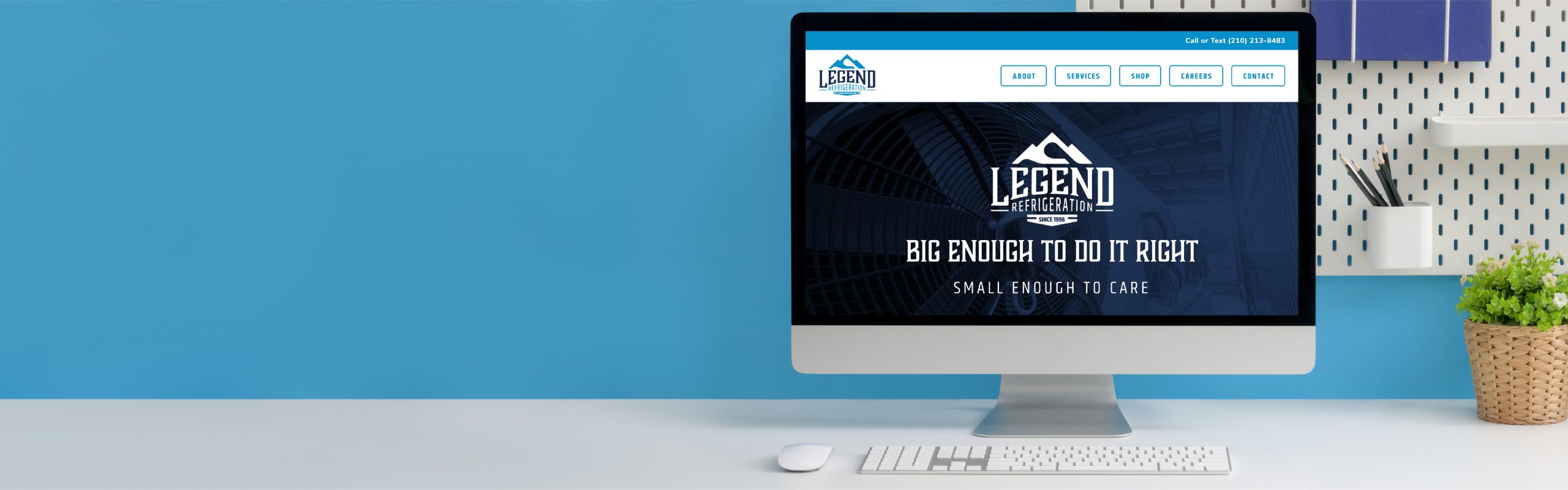A desktop computer placed on a white table displaying the homepage of a company named "Legend Refrigeration" on its screen, with a slogan that says "big enough to do it right small enough to.