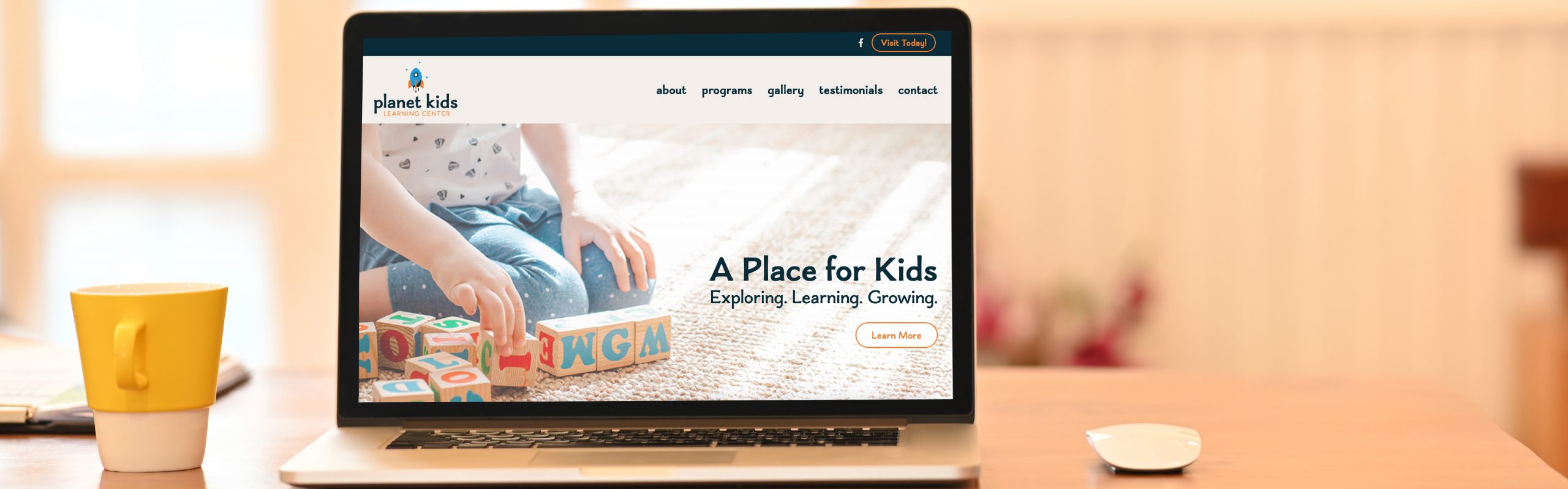 A laptop screen displaying a website called "Planet Kids Learning Center" with a banner that reads "a place for kids - exploring, learning, growing," showing an image of a child playing with building blocks