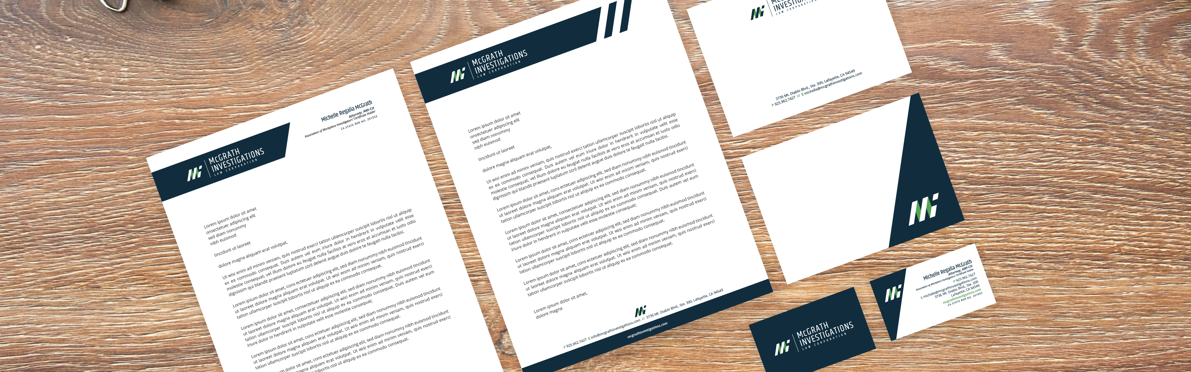 A collection of McGrath Investigations corporate stationery items, including letterheads, business cards, and envelopes, laid out on a wooden surface, showcasing a cohesive brand design.