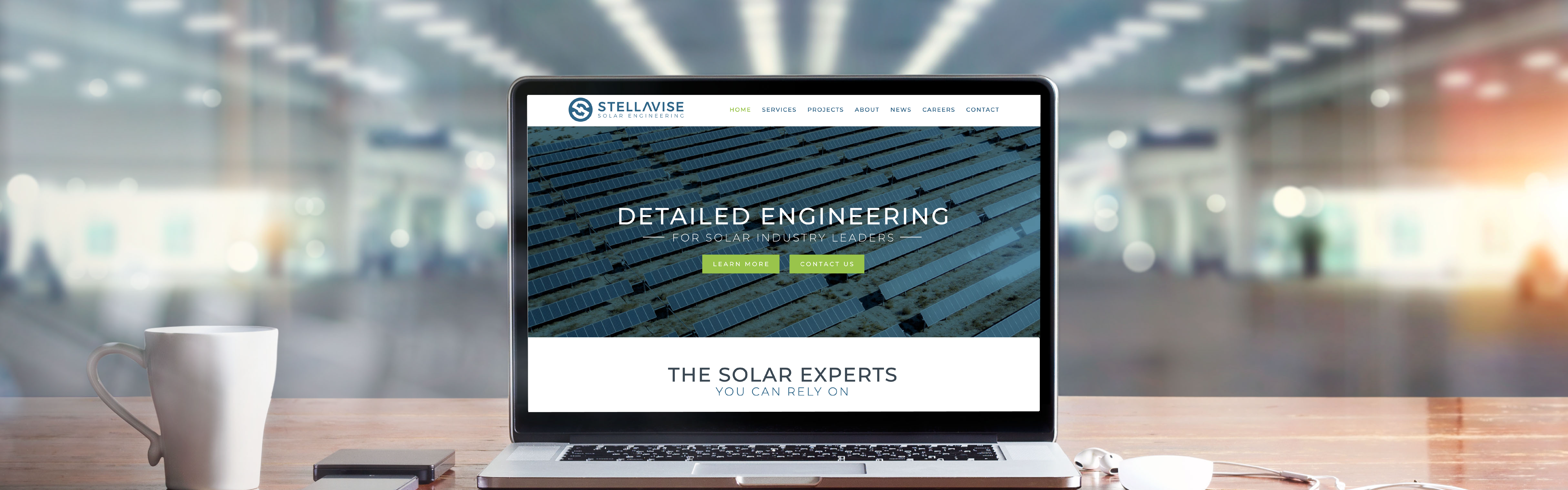 A laptop is open on a desk displaying a website for a company named "Stellavise" which specializes in detailed engineering for solar energy solutions, with a tagline "the solar expert.