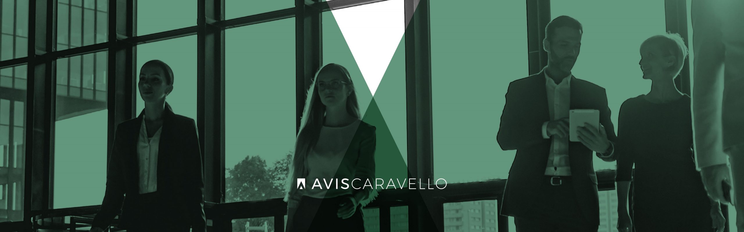Four professionals walking through an office space with large windows in the background, displaying a muted color palette with a green overlay. Avis Caravello is among them.