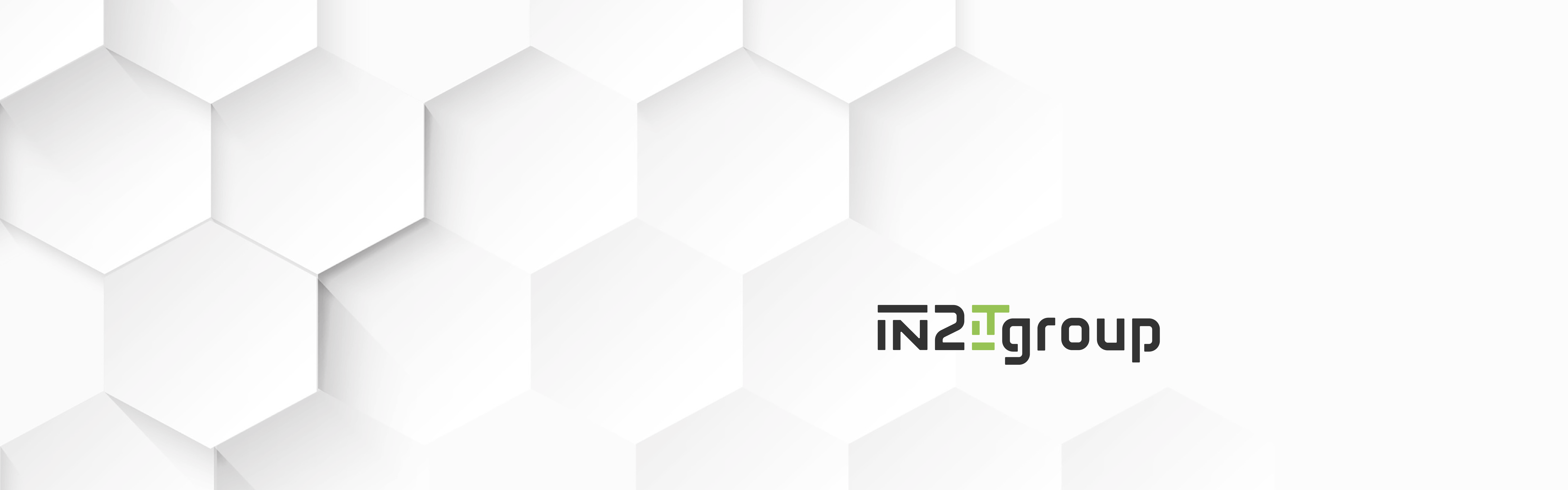 A graphic design featuring a white background with an array of hexagonal shapes to the left, transitioning from 3D to flat appearance, and text on the right that reads "IN2IT Group".